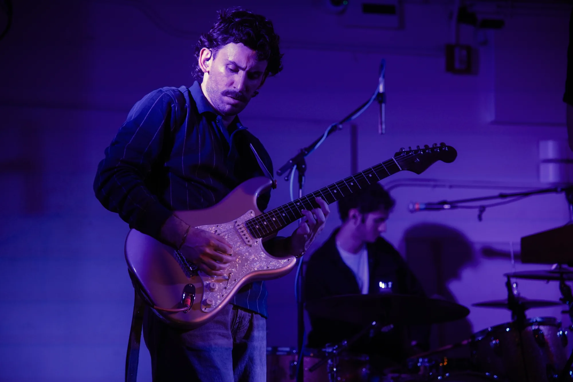 MoonWater guitarist playing during a live set
