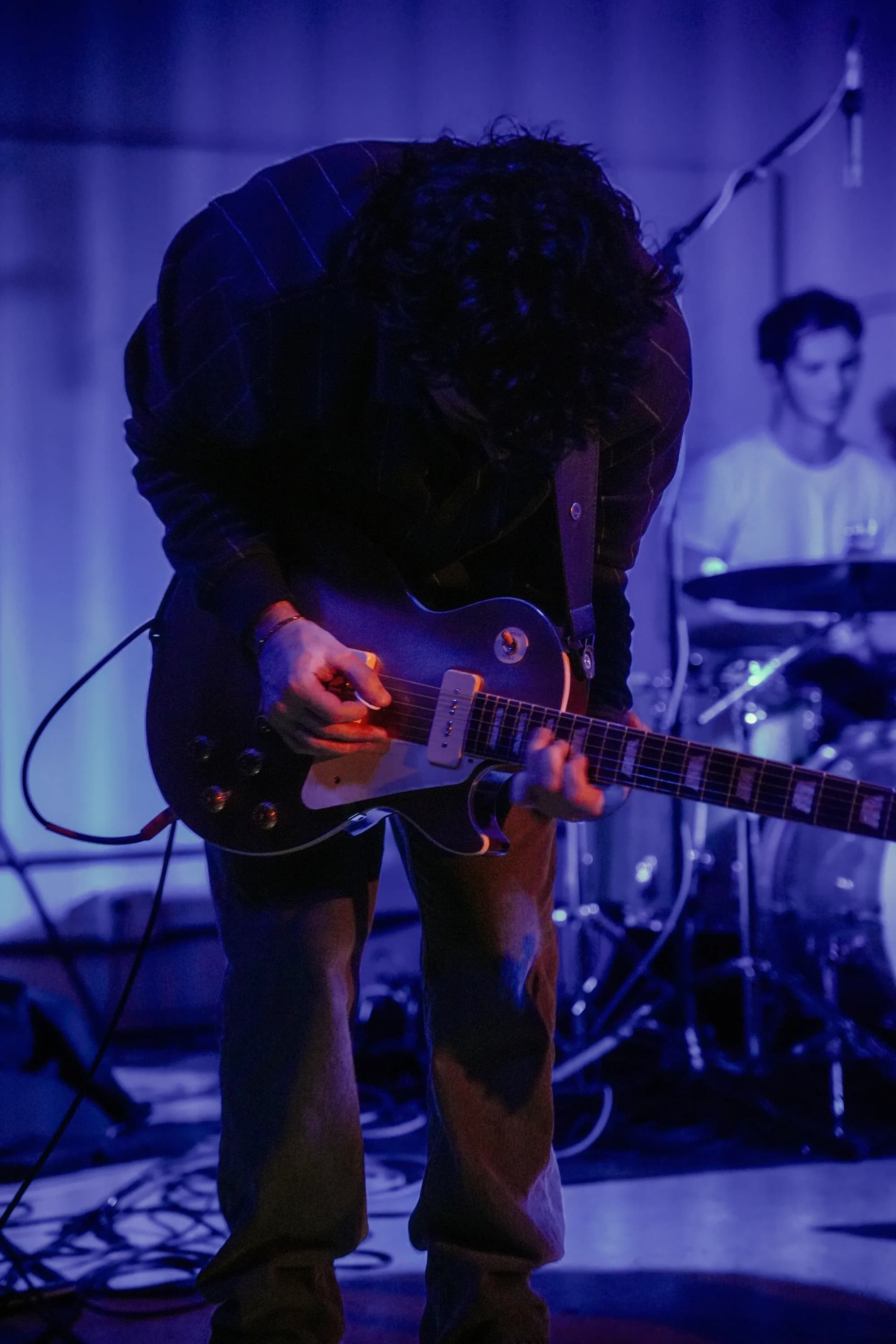 Vertical portrait of a MoonWater guitarist performing